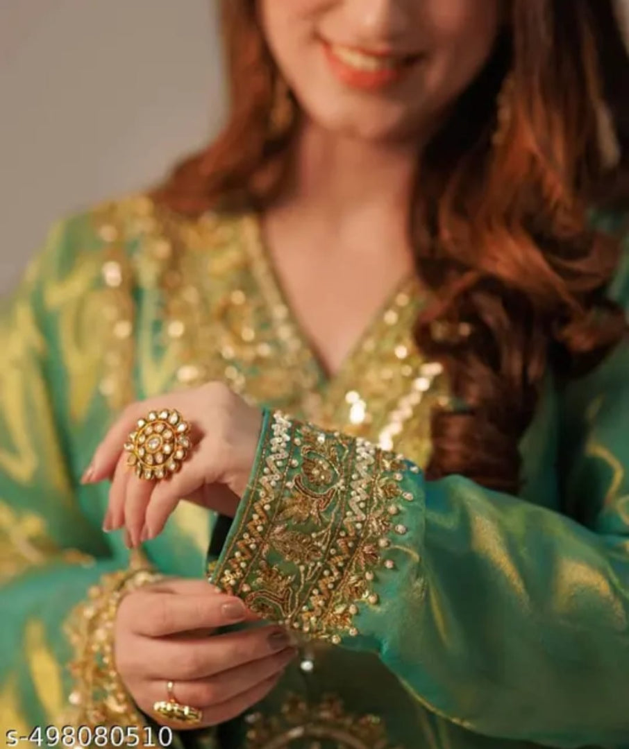 Silk Shimmer Turquoise and Green with Golden detailing, giving it a rich and luxurious appeal.with a Jimmy Choo-inspired finish features intricate sequins and thread embroidery.