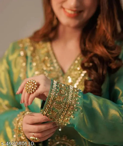 Silk Shimmer Turquoise and Green with Golden detailing, giving it a rich and luxurious appeal.with a Jimmy Choo-inspired finish features intricate sequins and thread embroidery.